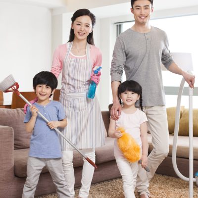 Cheerful Chinese family doing chores at home